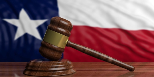gavel on Texas US of America waving flag background.
